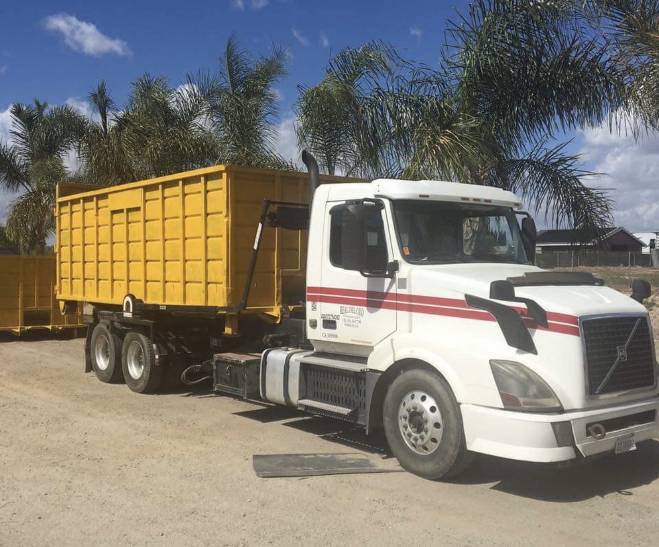 White RDO truck carrying a yellow container